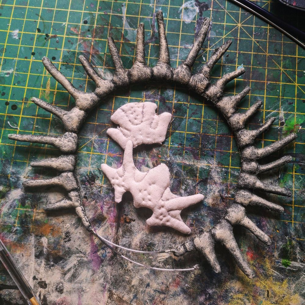 Photo of a spine-like circle and stuffed calico shapes