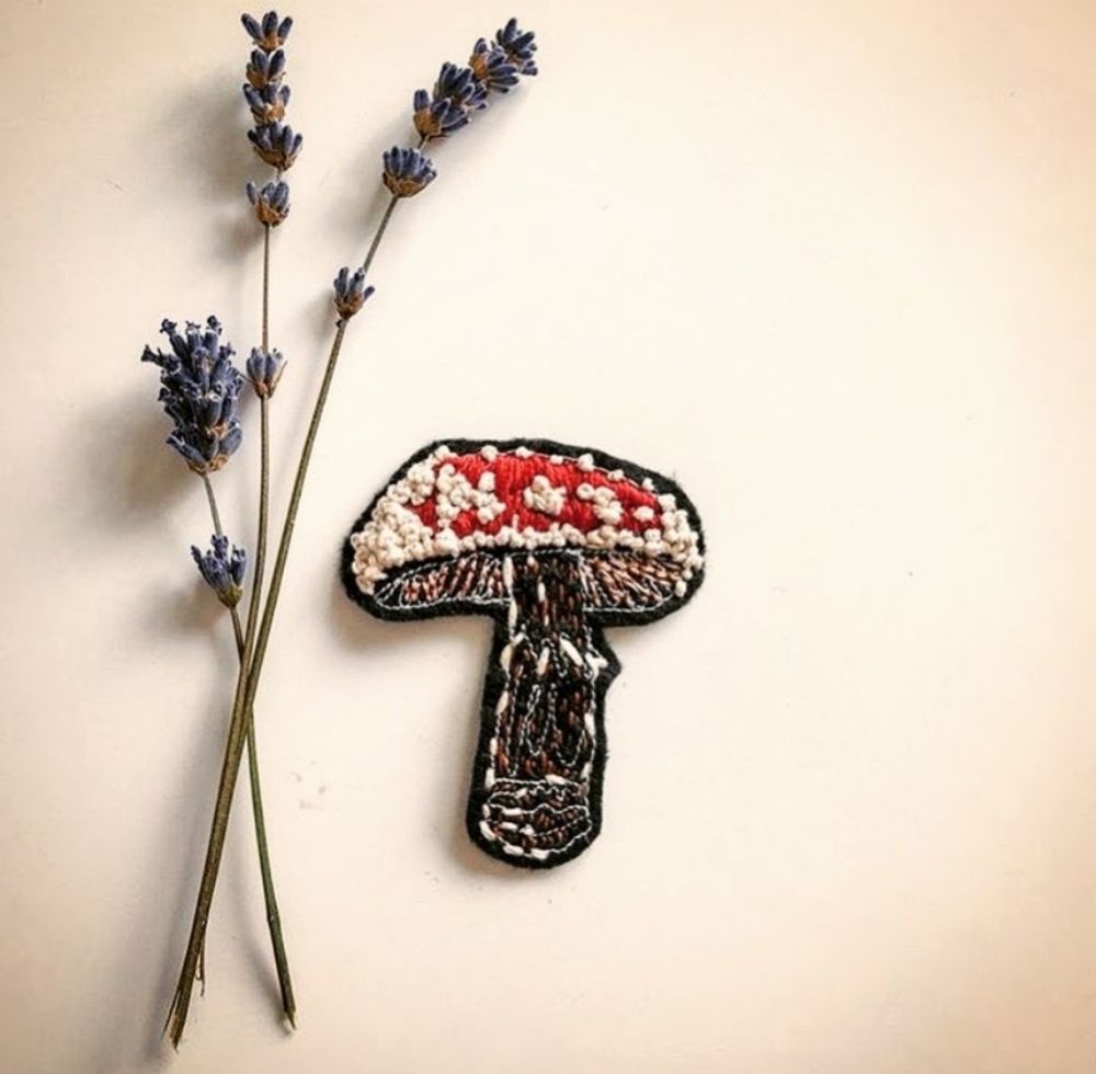 Handmade felt patch of an amanita muscaria mushroom with sprigs of lavender 