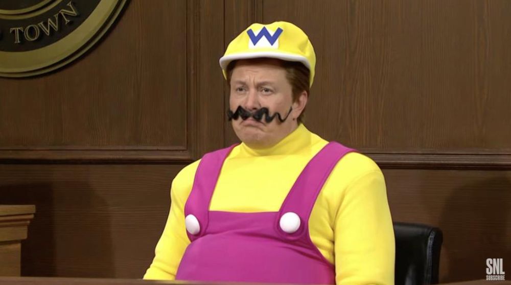 a photo of Elon Musk dressed as Wario sat in a courtroom for Saturday Night Live