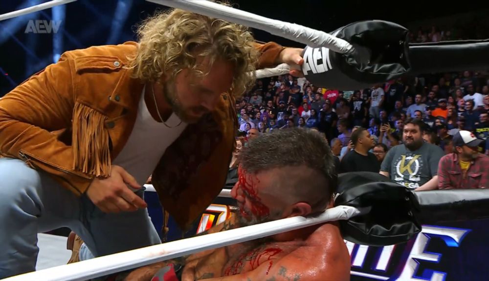 hangman leaning over and checking on mark briscoe