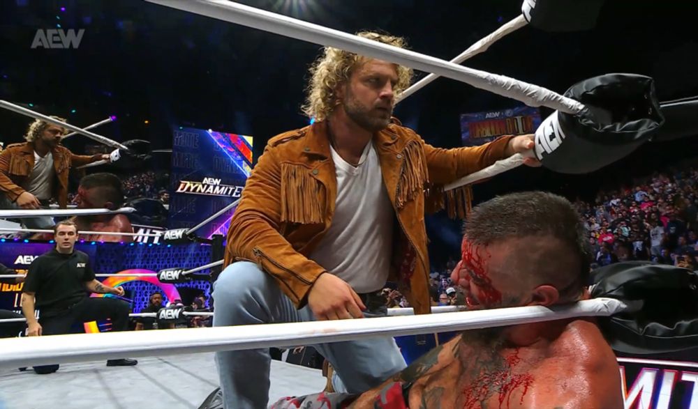 hangman still kneeling over mark and looking in the audience for mjf 