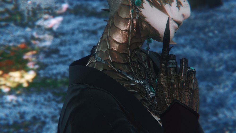 a close up of cyma's golden scaled neck and the drape of the neckline