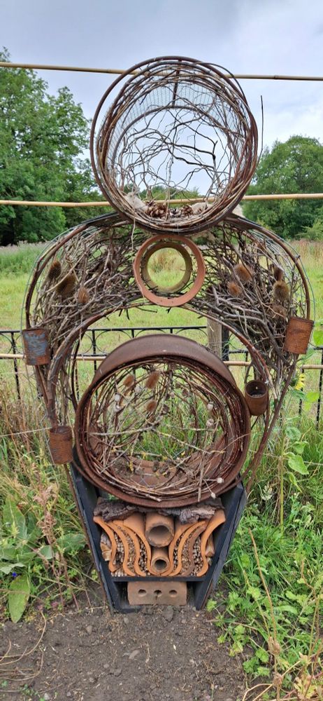 A wire and orange toned things including seeds make up a sculpture by Mike Stephenson and Angela Tracy called Erda "power of life"