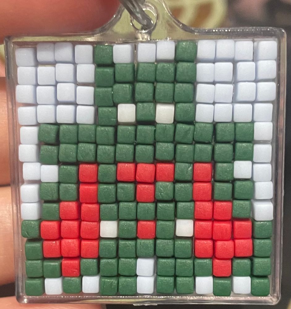 pixel art keyring of a very simplified Batman beyond Batman 