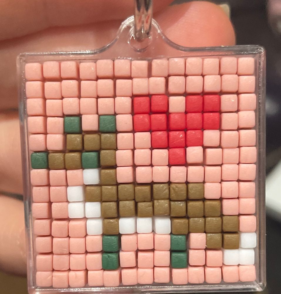 pixel art keyring of a fox standing and a heart in the corner 
