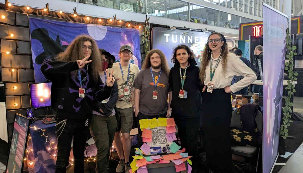 A commemorative photo of the Standing Cat developers who appeared at PAX East! From left to right: Ethan, Xavier, Kaleb, Ian, Nami, Hannah. The team poses in the booth with a banner of the Nekomancer and the game's logo in the background. In front of the team is a CRT running the Nekomancer of Nowhere demo trailer. The CRT is covered on all sides with sticky notes! Each sticky note features a fan drawing created during PAX.