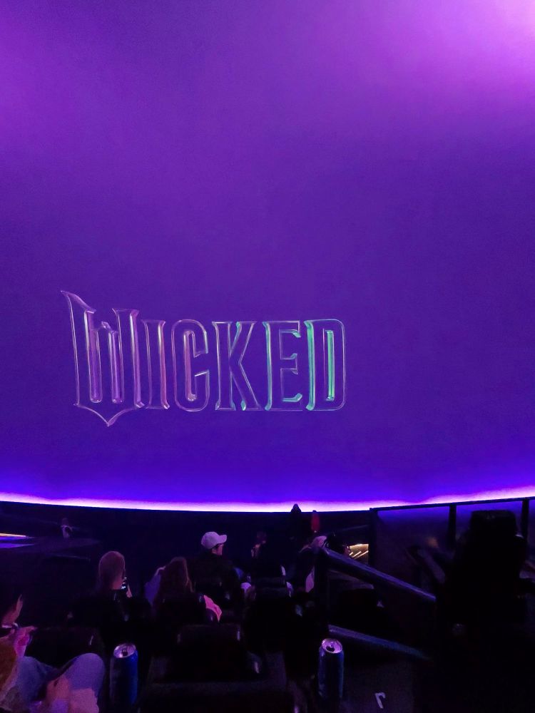 A purple screen with the Wicked movie logo