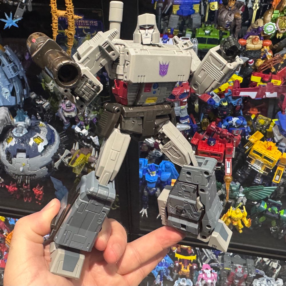 Studio Series Transformers The Movie Megatron posed in front of one of my display cases in hand.