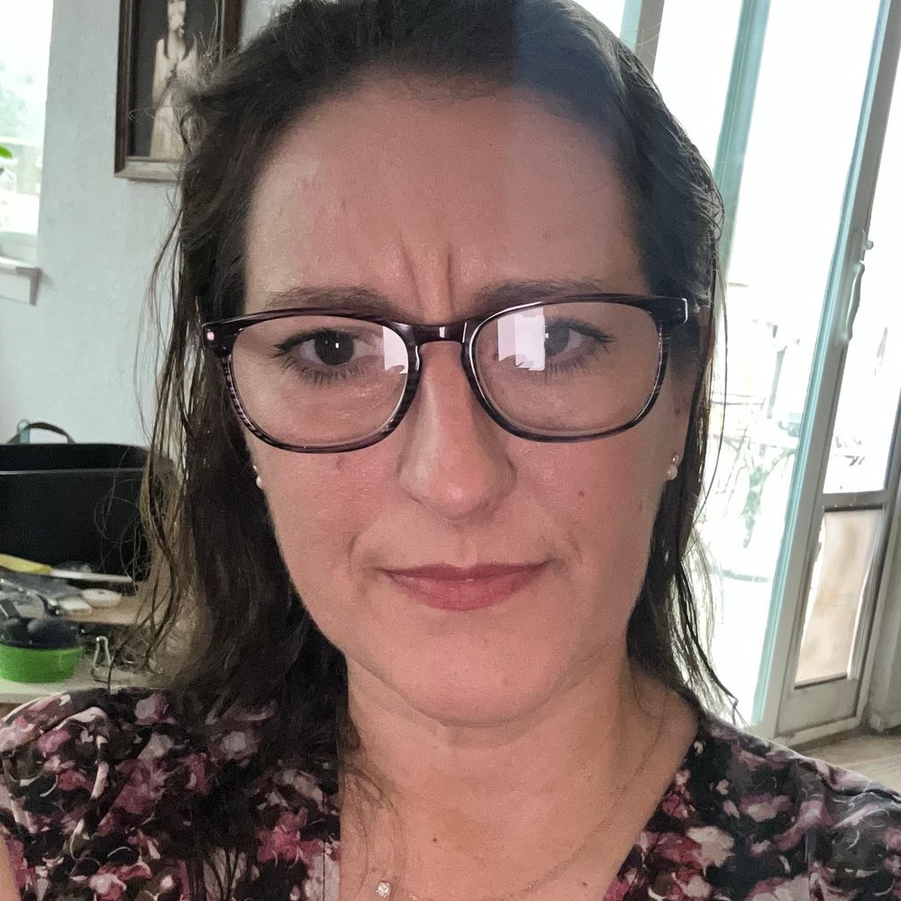 A selfie of me, a brown-haired woman, wearing glasses.