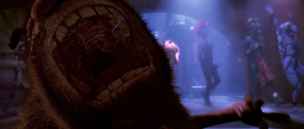 A screenshot from Return of the Jedi, showing a furry CG creature screaming into the camera. 