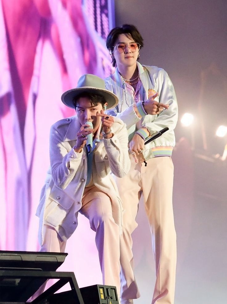 J-Hope and Suga during a Permission to Dance on stage show giving finger
hearts and gestures to the camera