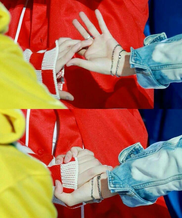 A close up of Suga and j-hope grabbing each other’s hand in a DNA dance formation 