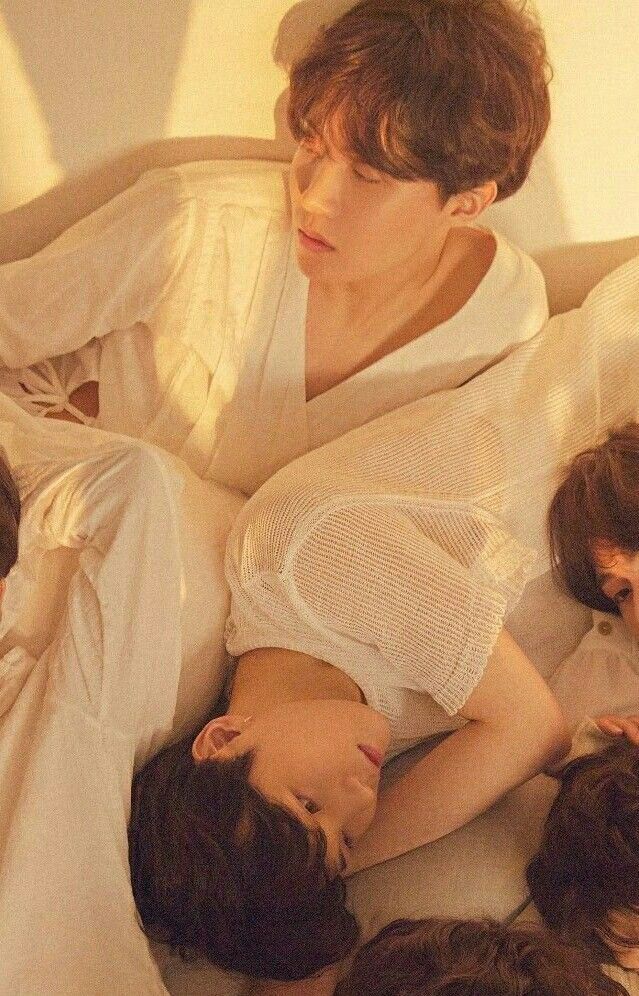 A crop of J-Hope and Suga from a Love Yourself:Tear photoshoot where all the members are wearing white and piled on the floor.