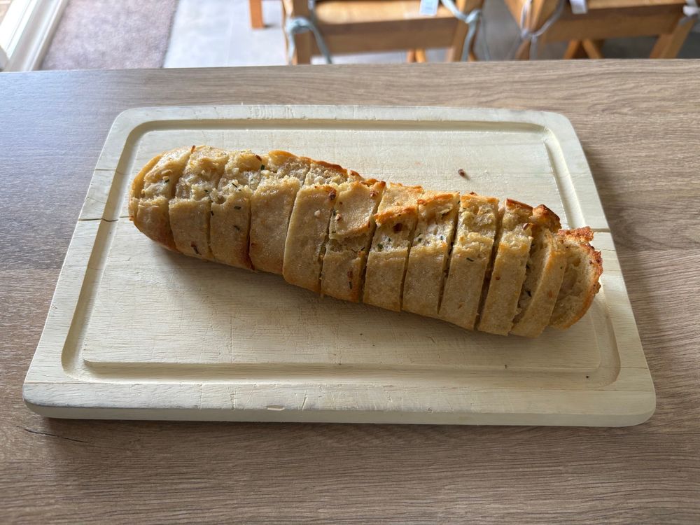 Garlic bread on a chopping board.