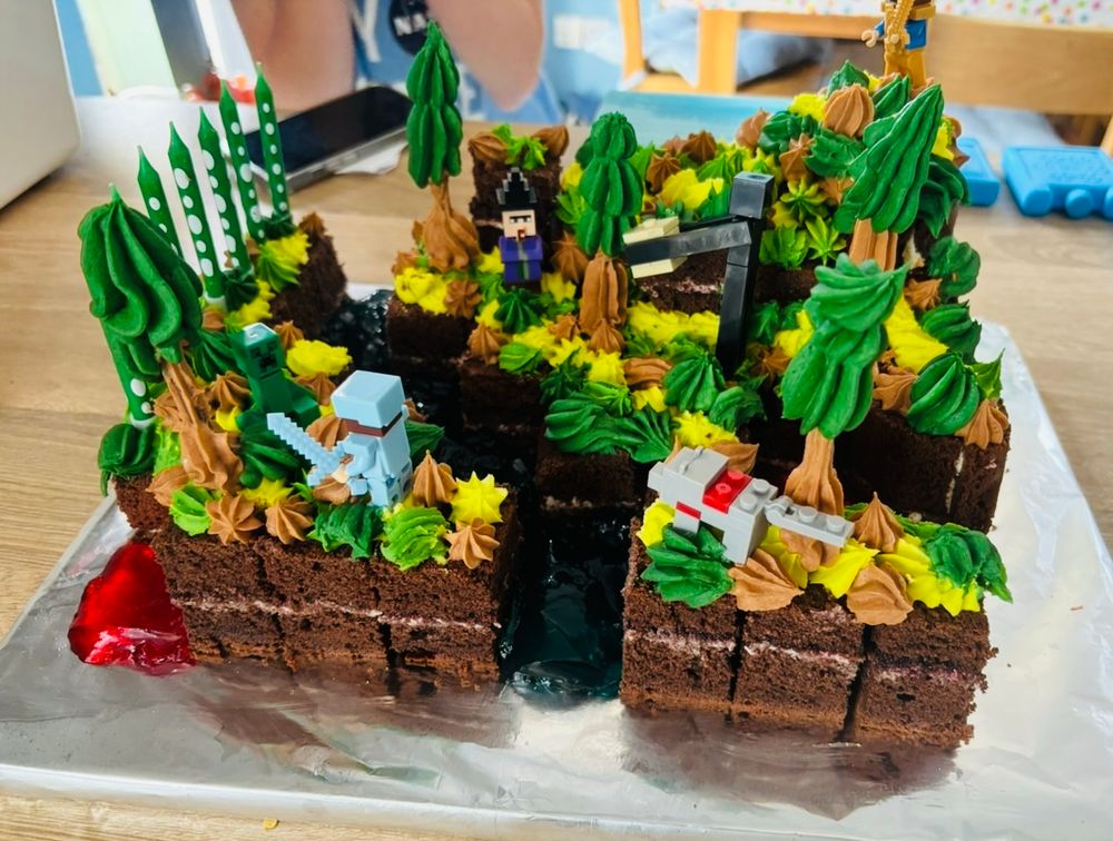 Chocolate cake with trees and figures in the style of Minecraft