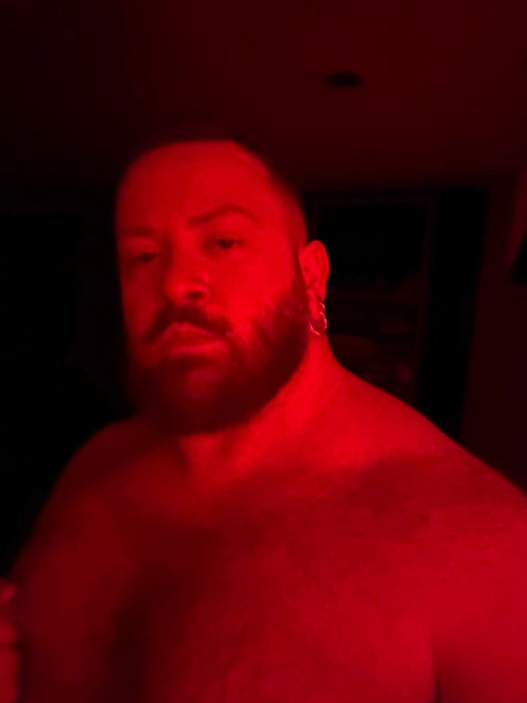 Attempted seductive selfie from my hairy chest to the top of my head all lit in red. 