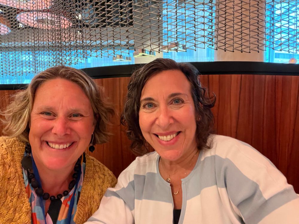 Two women smiling at the camera.
