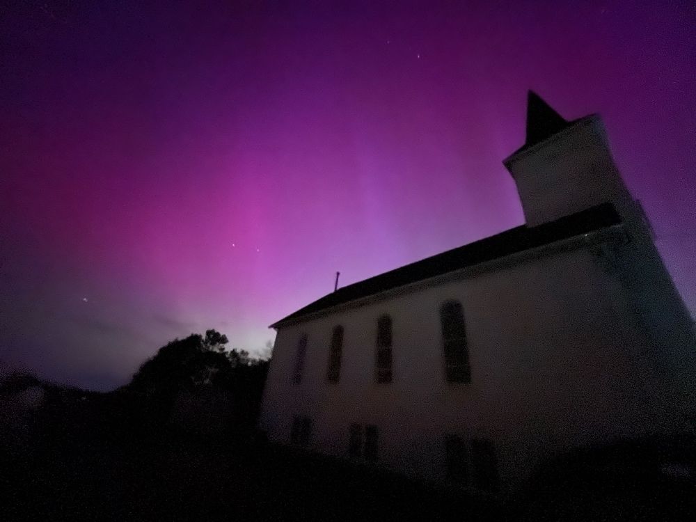 Aurora in Buffalo NY behind a church.