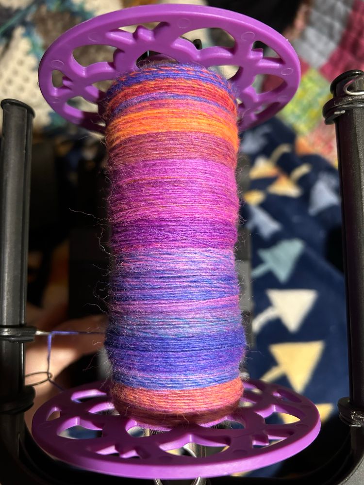 A bobbin partially full of a spun single from the previous picture. 