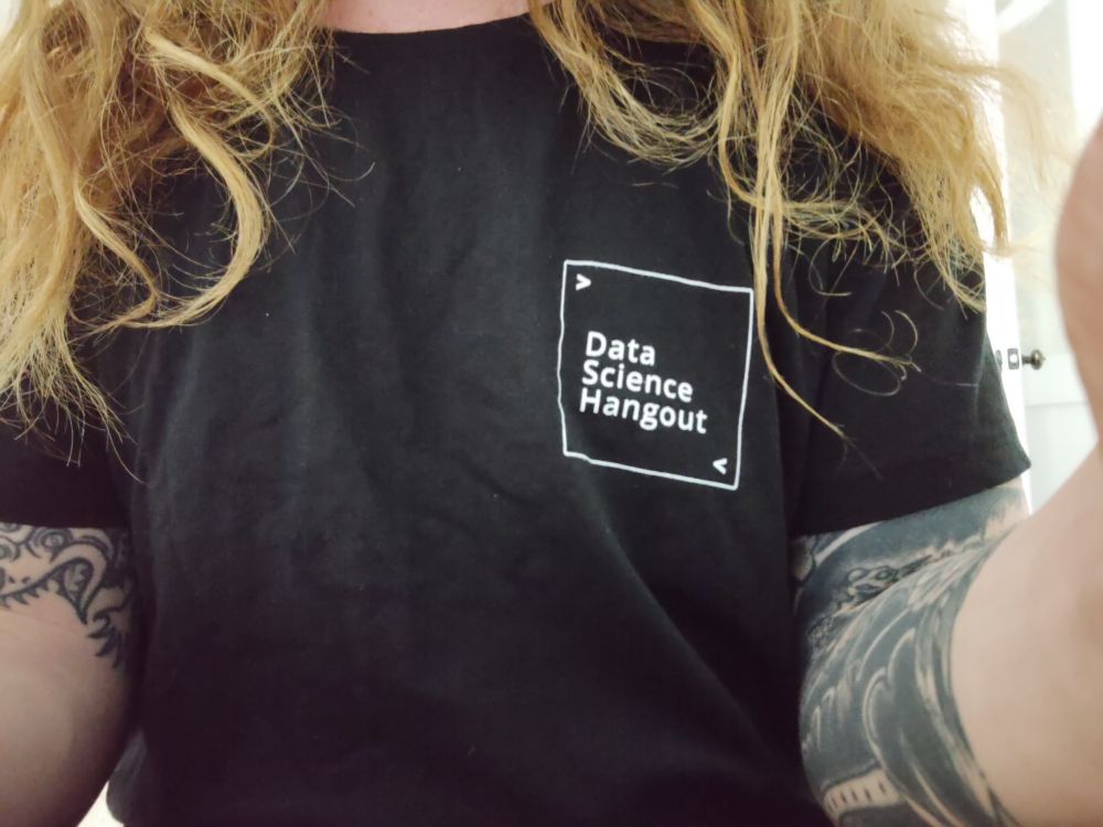 Picture of a torse in a black shirt that says 
"
>
Data Science Hangout
<
"