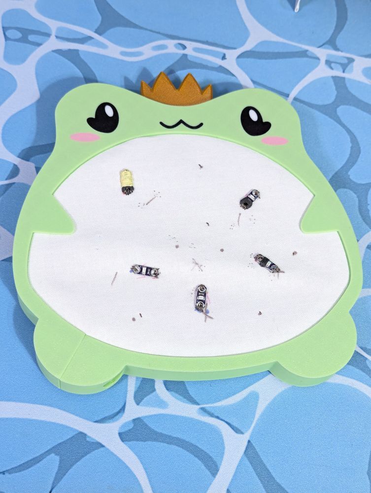 embroidery hoop shaped like a frog with led lights stitched on