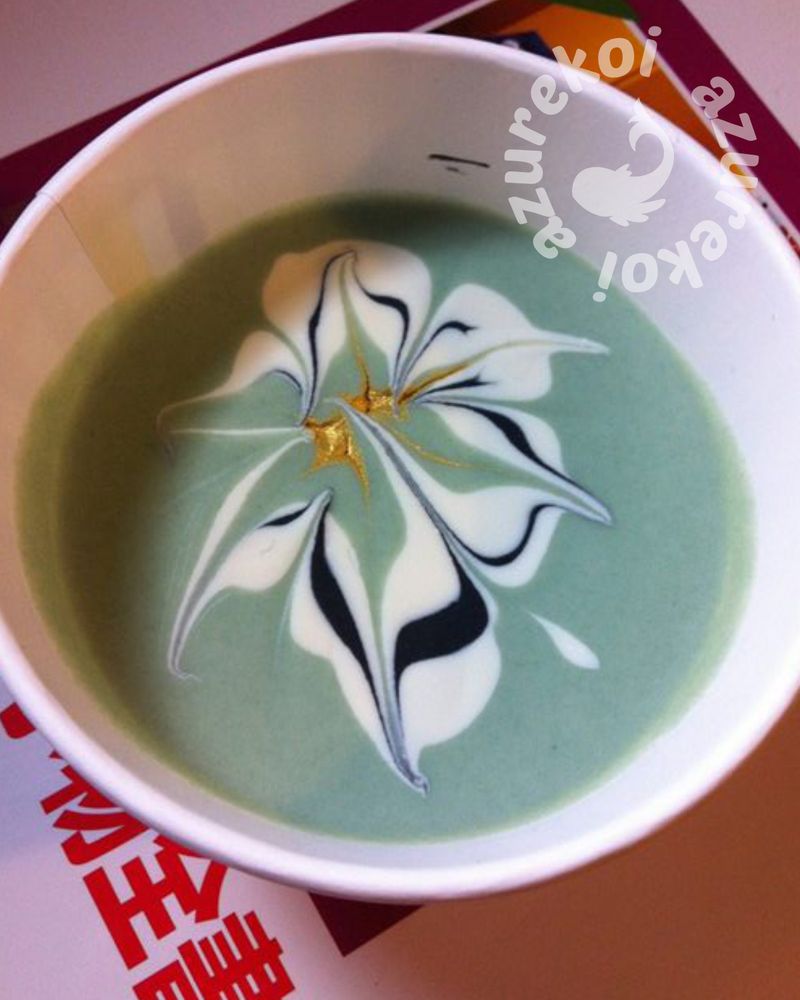 jade green soap with a black and white flower with gold centre