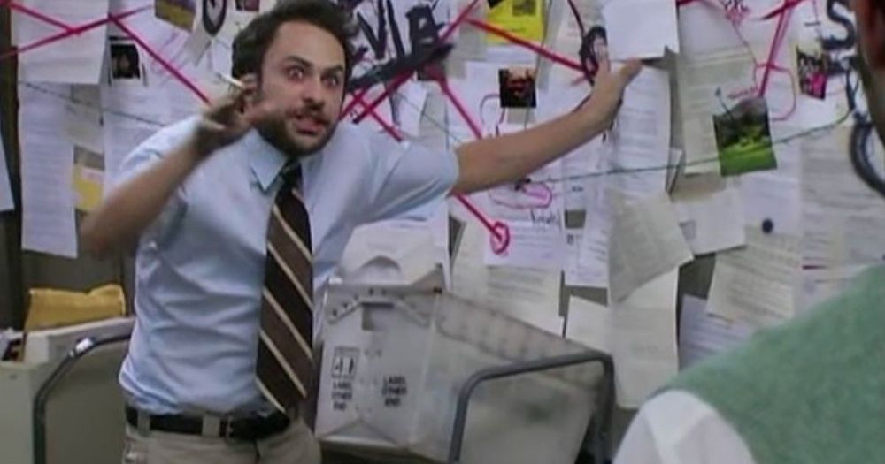 Charlie from Always Sunny gesturing towards a collection of documents connected by red yarn 