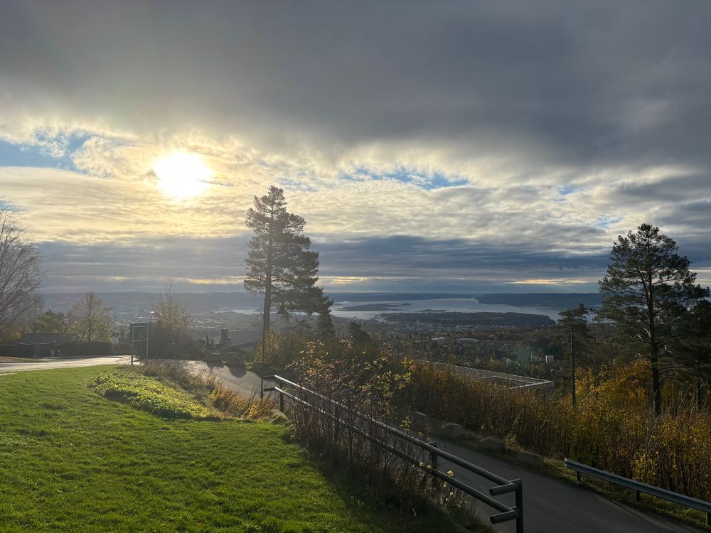 Oslofjorden from Holmenkollen with the sun peeking down on us between the clouds.