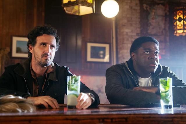 Sam Richardson sits at a bar with some other guy in POKER FACE 