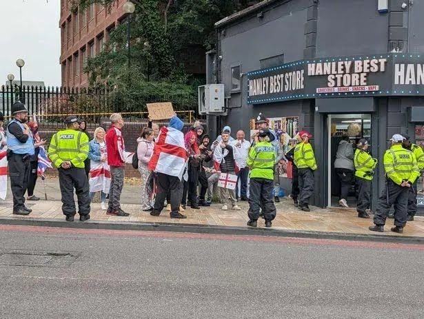 Small crowd of flag-wrapped xenophobes in Stoke who are almost outnumbered by police