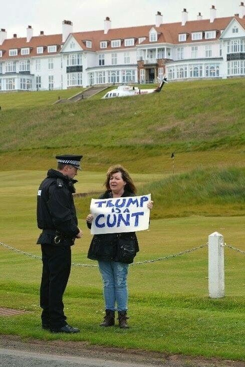 photo of Janey  Godley with her "Trump is a Cunt" sign near his golf course 