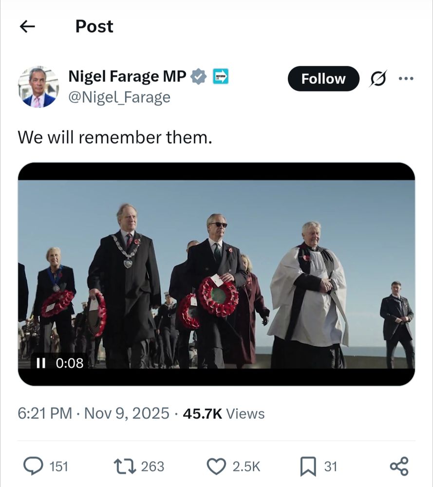 6.21PM Nov 9 2025 s/s of tweet by Nigel Farage saying We Will Remember Them while showing a stylish video which includes slomo shots of him holding a wreath while wearing a suit and sunglasses in between mayor and a vicar in robes 