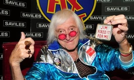 photo of flamboyant sexual predator paedophile and alleged necrophiliac Jimmy Saville  holding a "Jim Fixed It For Me" badge from his Jim'll Fix it show
