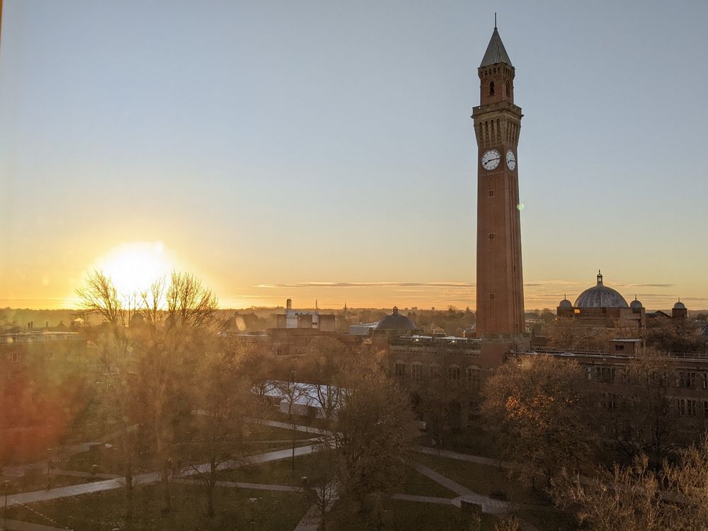 Photo of the university of Birmingham campus in autumn as the sun rises in a blaze of light, illuminating Old Joe, the tallest freestanding clock tower in the world (unless someone has built something taller in Dubai now, I haven't checked)