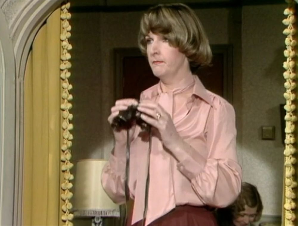 Photo of Penelope Keith surveying the scene at Dealey Plaza in 1963
 (just kidding, it's a still from To The Manor Born where she's using her binoculars to spy on her neighbour)