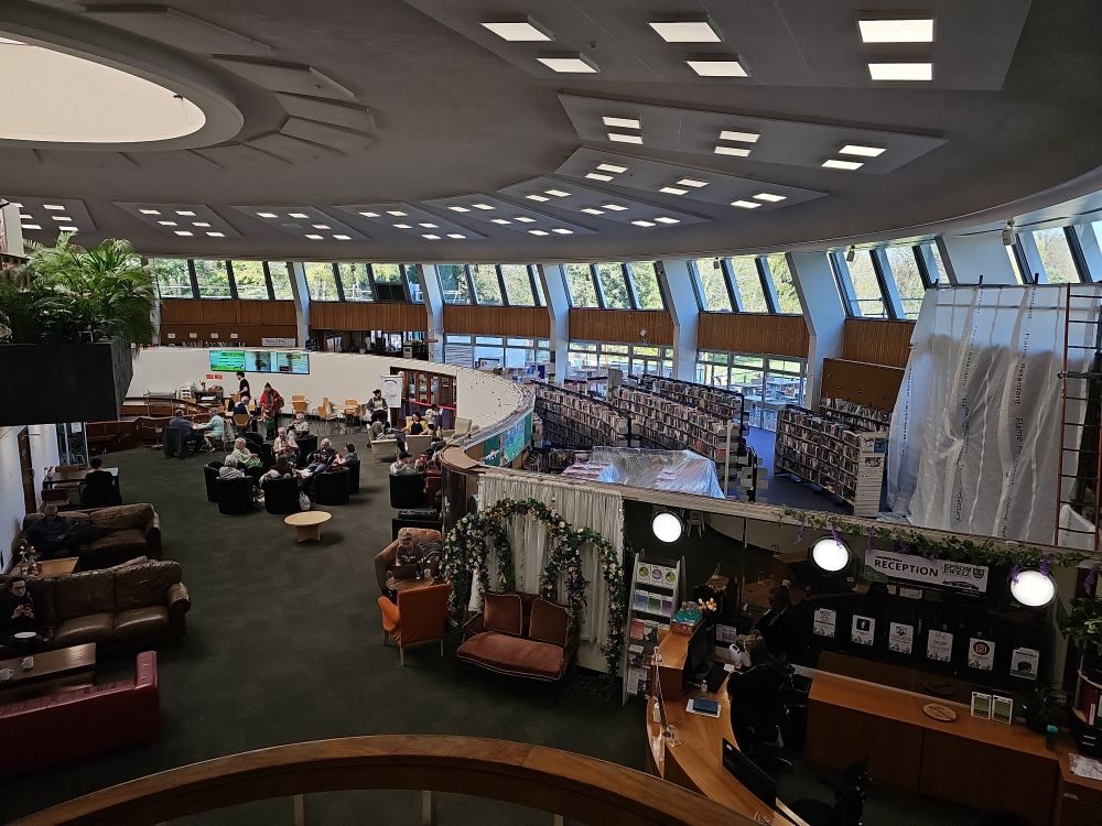 Photo looking down from the upper floor at Bourne House, showing the social and library areas inside the "flying saucer"