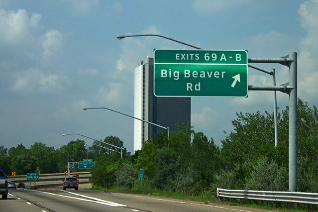 a road sign, exit 69 Big Beaver Rd