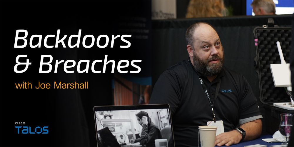 A man, identified as Joe Marshall, sits in front of a laptop displaying a black and white image. The background features a booth setup, and the text 'Backdoors & Breaches' is prominently displayed in white on the left side, with 'with Joe Marshall' below it.