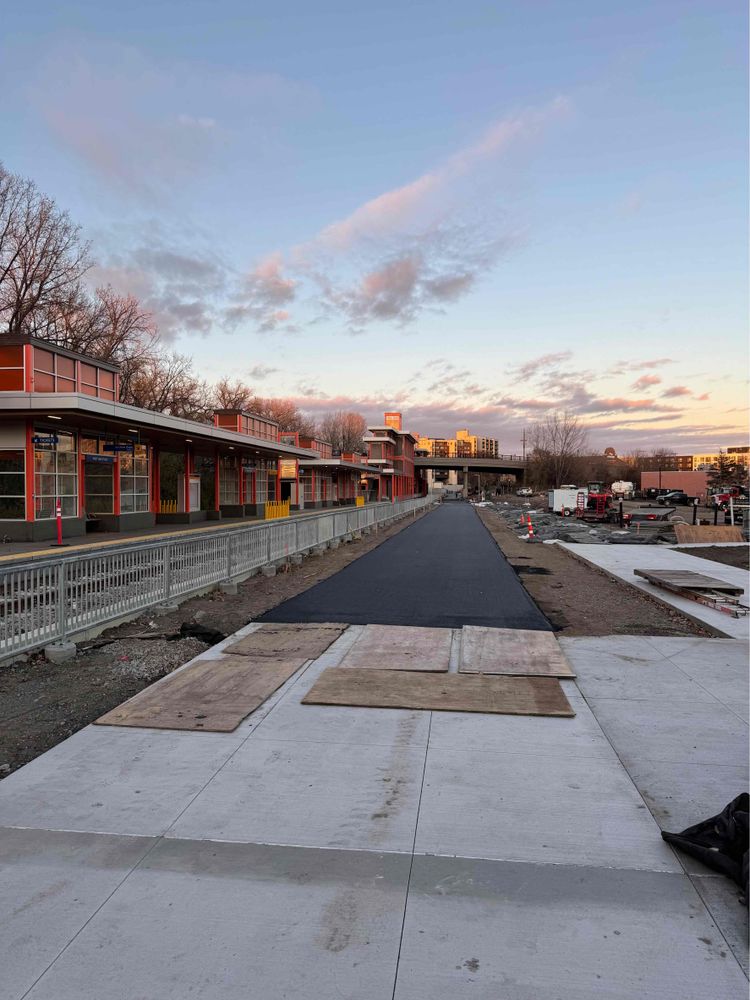 Looking northeast along the West Lake St., Station with fresh pavement next to it.