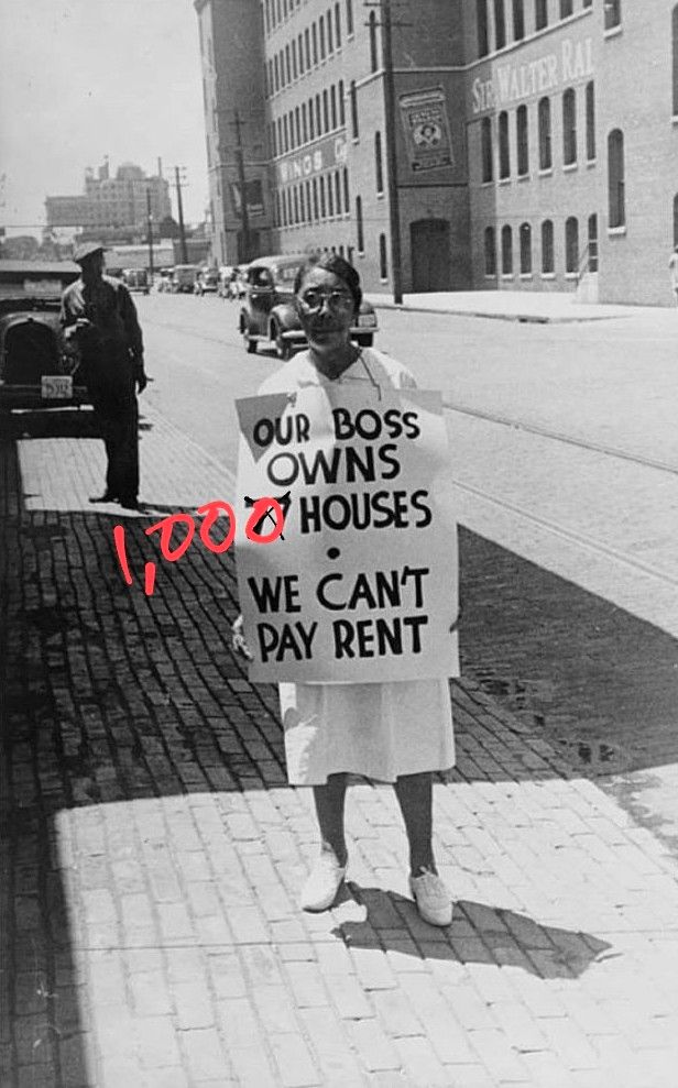 A black and white photograph of what looks like the 30s and a woman protesting with a giant sign that says BOSS OWNS 77 HOUSES * WE CAN'T PAY RENT but I've made 77 into 1,000