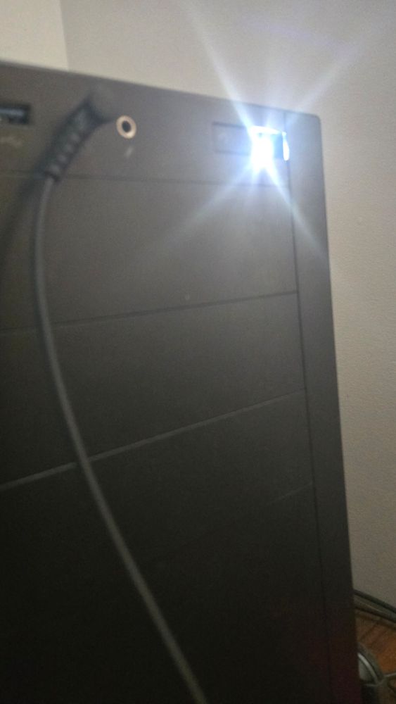 A pc tower with the power button half broken 