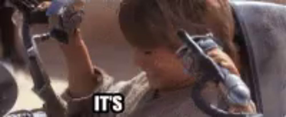 a close up of a person holding a gun with the words `` it 's '' written on the bottom .