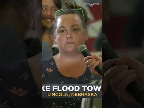 Town hall erupts as woman confronts Rep. Flood over border stance: “How much does fascism cost?”