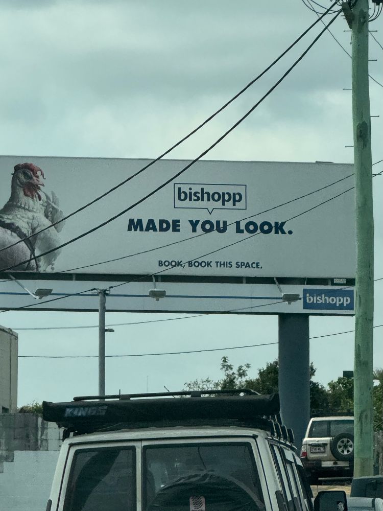 picture of a billboard with the brand labeled 'bishopp' and then underneath it says 'MADE YOU LOOK.' and a picture of a chicken for some reason. it reminds me of the pilots obviously. 