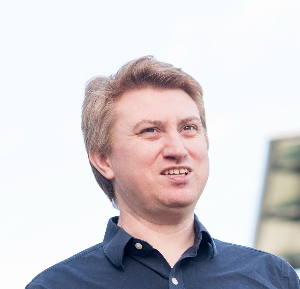 Head and shoulders picture of Professor Graham Cormode, a white man wearing a blue collared shirt