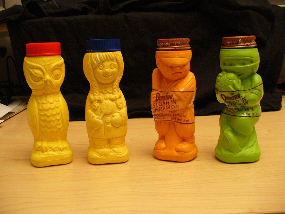 Vintage plastic shakers of Domino Sugar 'n' Cinnamon blend produced by the American Sugar Co., later Amstar Corp., in the 1960s & '70s. The blend, favored by American kids as a topping for toast, oatmeal and other hot breakfast cereals, waffles and pancakes, is still available, albeit in packaging with less child-oriented appeal. The roughly 5-inch-tall shakers were collected by some & used to store pennies, among other things. Photo via Ebay.