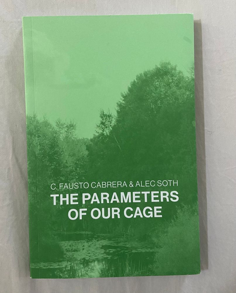 A photograph of a green book cover with the title “The Parameters of our Cage.” The green photograph depicts a pond with lily pads framed by trees and shrubs. 