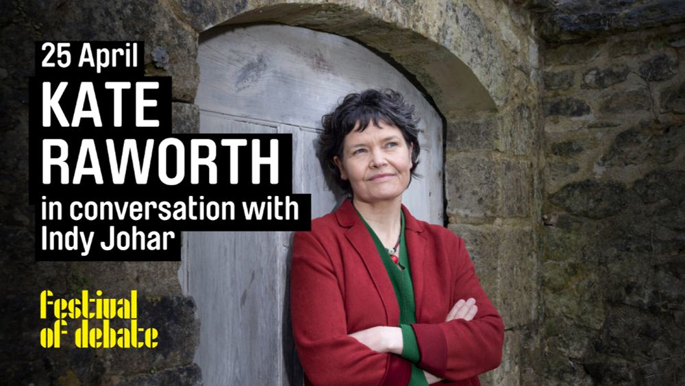 A photo of a woman wearing a red coat leaning against what looks like a church door with her arms folded, and smiling at something off-camera. Superimposed on this image is the text "25 April. Kate Raworth in conversation with Indy Johar", with the Festival of Debate logo