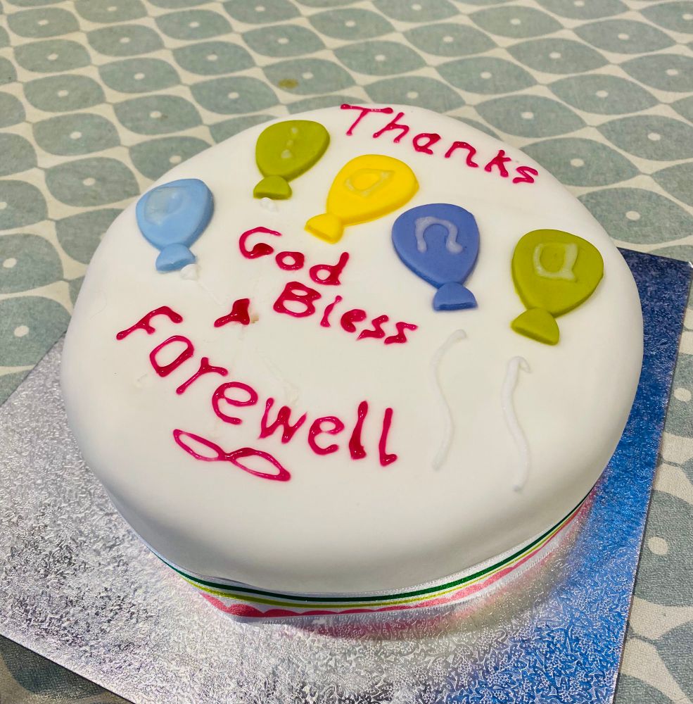 Cake reading ‘thanks Diana. God bless and farewell’. 
