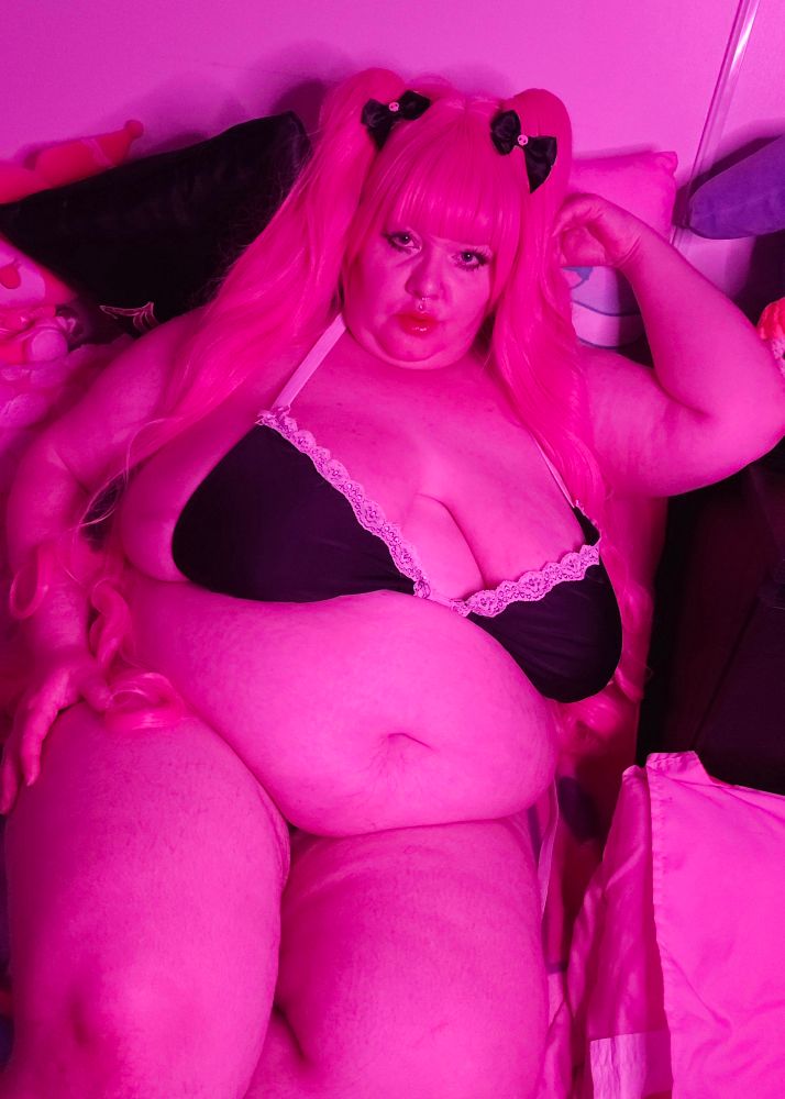 Bunny bathed in pink wearing tiny black ruffle bikini top with boobs and fat hanging out. Wearing pink perona cosplay wig looking sexy af with kuromi hair bows